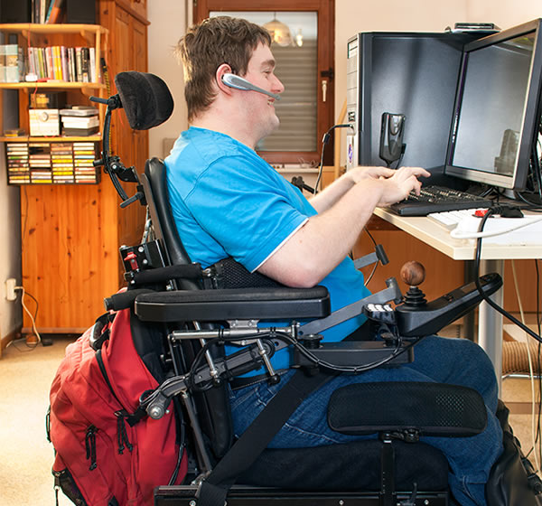 Persona en silla de ruedas utilizando computadora